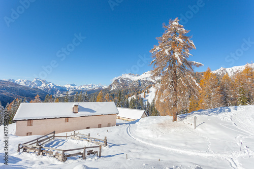Alpine hut in front of an awesome winter scenery, Val Fiorentina, Dolomites, Italy. Concept: winter landscapes, Christmas atmosphere, Unesco world heritage