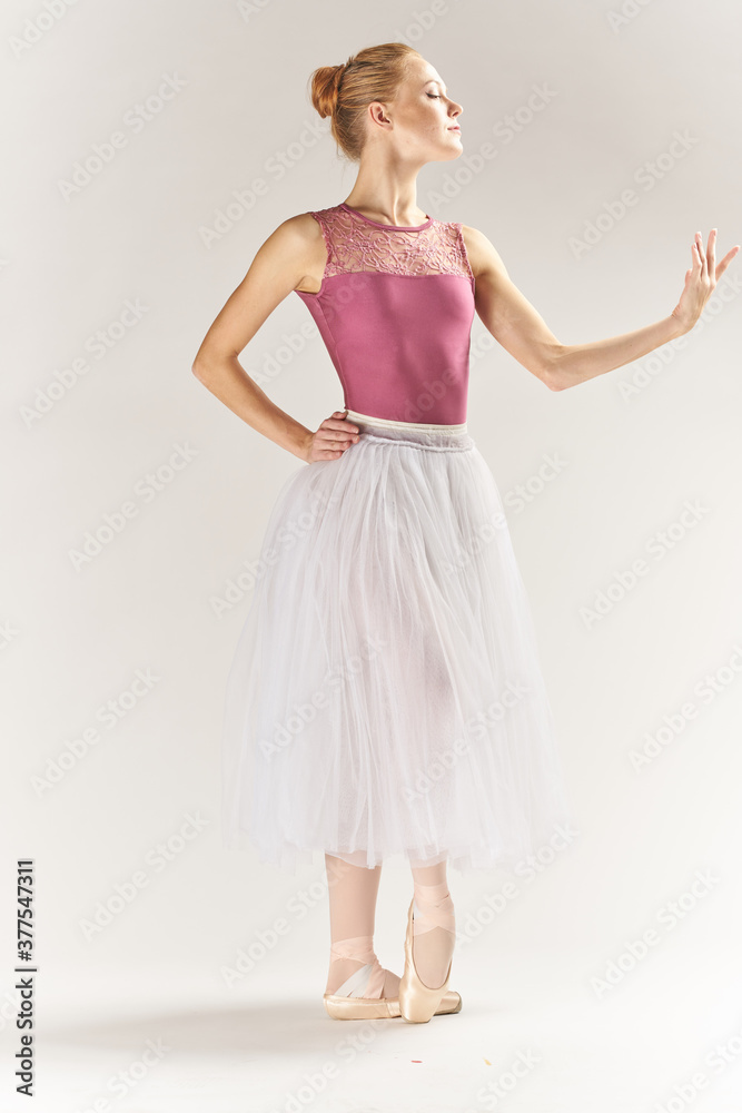 woman ballerina in pointe shoes and in a tutu on a light background poses posing legs dance model woman ballerina in pointe shoes and in a tutu on a light background poses posing legs dance model