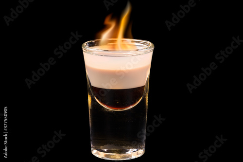 Amazing cocktail b-52 in a glass with flame,