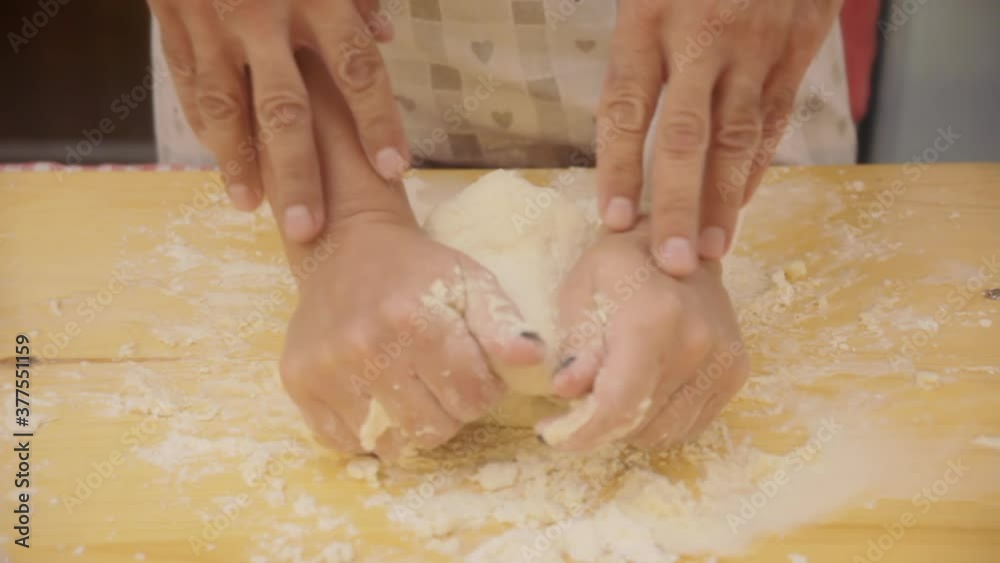 Front shot: the hands of a woman, kneading dough for a Focaccia (a flat oven-baked Italian bread product), helped by those of a man. Family moments, love, being together.
Front shot: the hands of a woman, kneading dough for a Focaccia (a flat oven-baked Italian bread product), helped by those of a man. Family moments, love, being together.