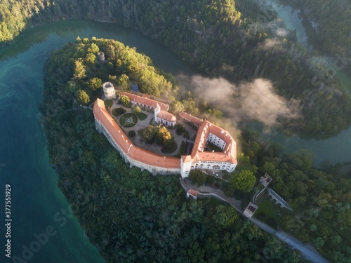 Bitov Medieval castle in South Moravia region during amazing sunrise, Czech republic, Europe. Aerial drone view. Summer or autumn time.
Misty and sunny atmosphere. photo