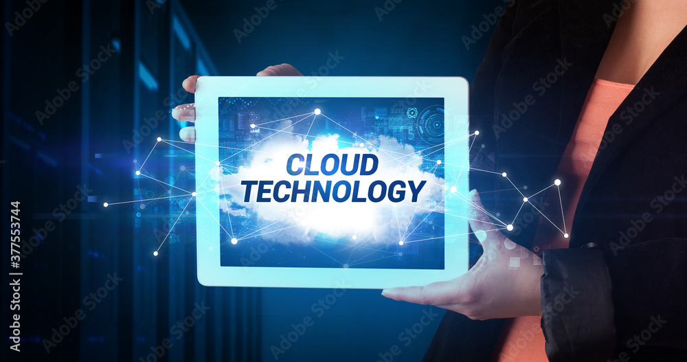 Young business person working on tablet and shows the inscription: CLOUD TECHNOLOGY Young business person working on tablet and shows the inscription: CLOUD TECHNOLOGY