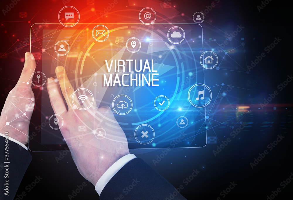 Close-up of a tablet with VIRTUAL MACHINE inscription, innovative technology concept
