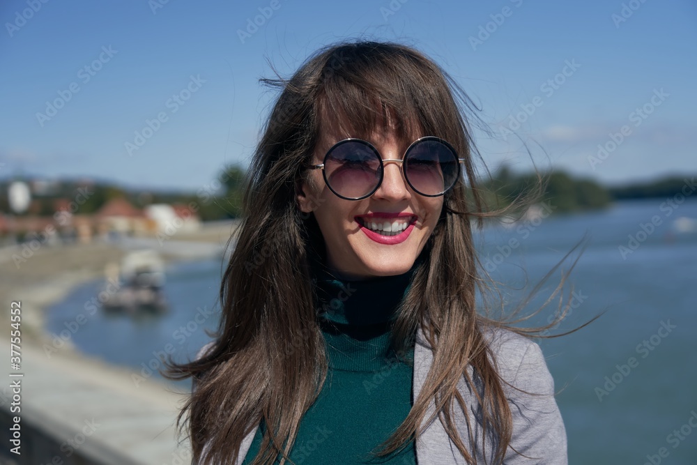 Outdoor portrait of white smiling woman in autumn landscape. Outdoor portrait of white smiling woman in autumn landscape.