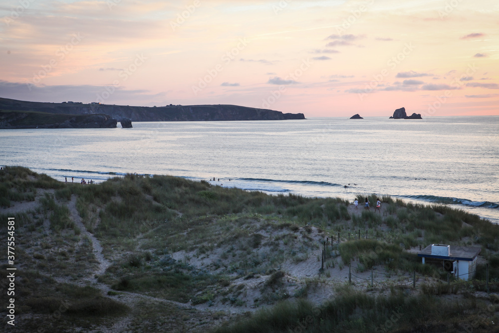 romantic view on the Atlantic ocean and the surf spot, sunset under the cliffs in Cantabria, Spain romantic view on the Atlantic ocean and the surf spot, sunset under the cliffs in Cantabria, Spain