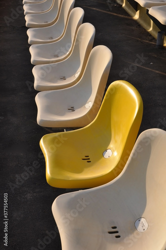 Stadium seat with one different Color, yellow, Hockenheim,one new Seat  beside of old one photo