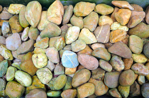 River rocks, stones, pebbles on the ground , brown color stones , beautiful background 