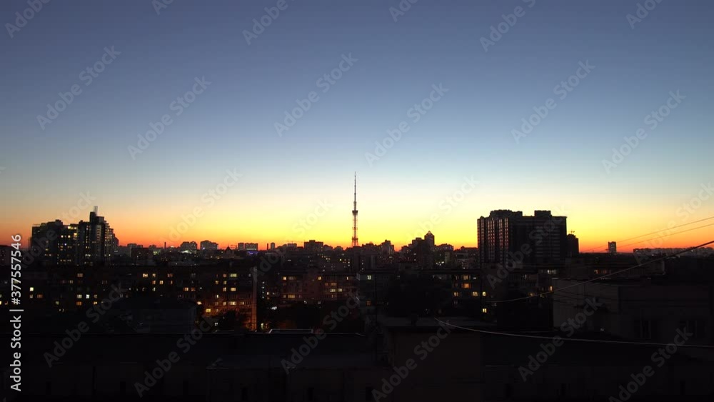 Silhouette of cityscape at sunset with TV tower in the center, timelapse. Silhouette of cityscape at sunset with TV tower in the center, timelapse.