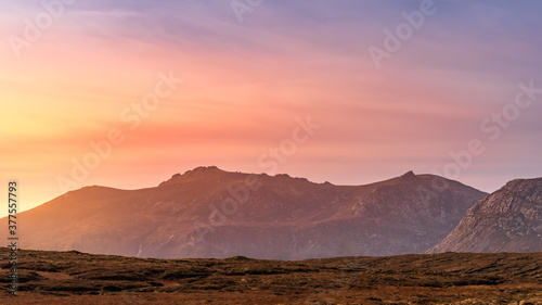 Dramatic sunset at mountain range. Setting sun highlighting Mourne Mountains, County Down, Northern Ireland