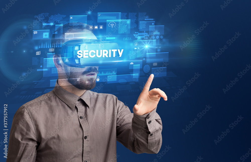 Businessman looking through Virtual Reality glasses with SECURITY inscription, innovative security concept Businessman looking through Virtual Reality glasses with SECURITY inscription, innovative security concept
