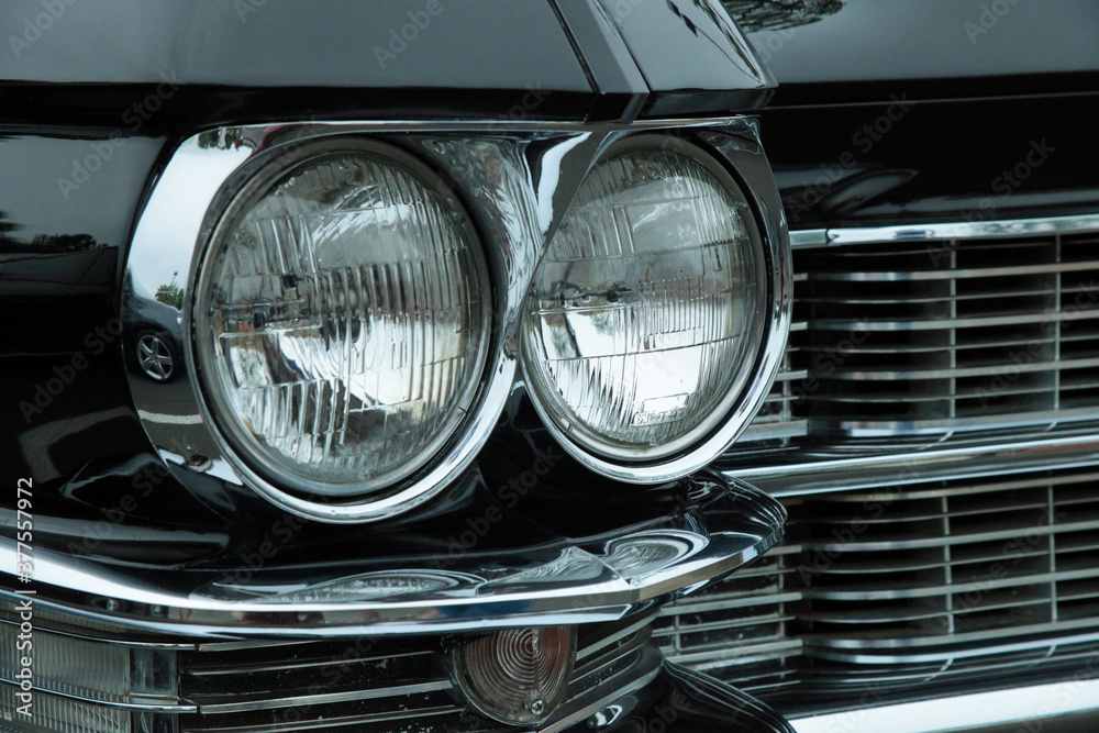 Close up of Grill and headlights of a classic american car, isolated