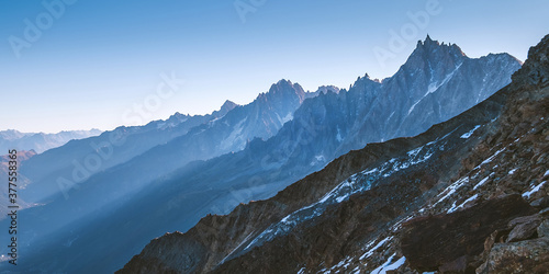 French Alps mountains wide angle landscape panoramic view with a Aiguille du Midi 3842m nature landmark peak during the Mont Blanc ascending via the popular Gouter Route in September month. photo