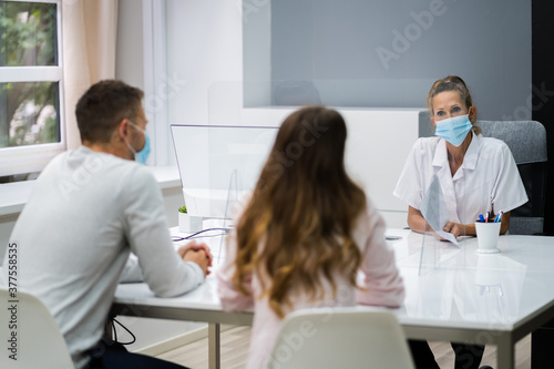 Doctor Talking To Patient At Meeting About Pregnancy