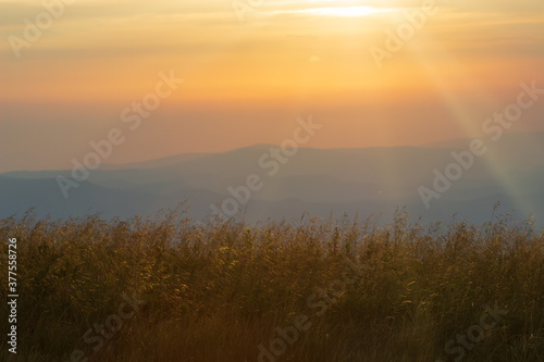 colorful sunset on top of austrian mountain alps © Shcherbyna