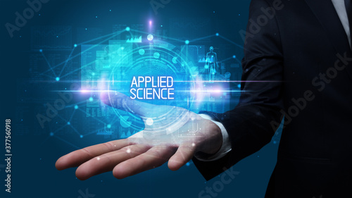 Wallpaper Mural Man hand holding APPLIED SCIENCE inscription, technology concept Torontodigital.ca