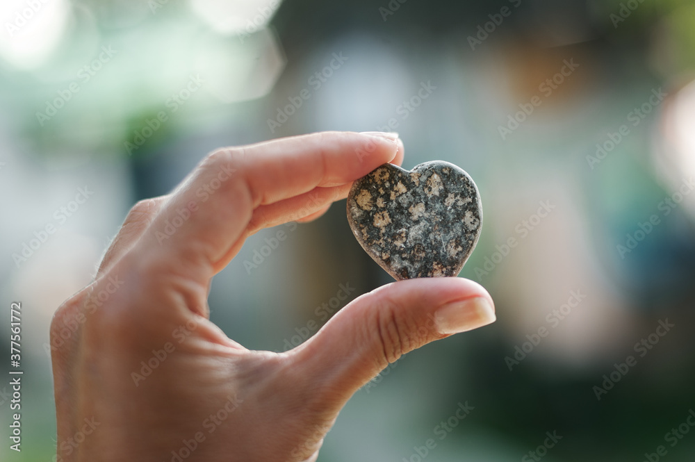 Heart made of stone in hand in nature Heart made of stone in hand in nature