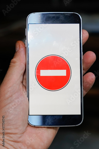 Access denied sign on smartphone screen in man hand photo