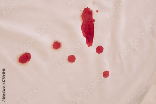 blood stains from menstruation in bed photo