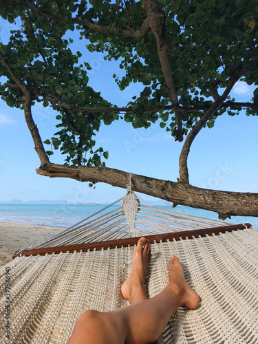 Relaxing in a hammock on a tropical beach in Krabi, Thailand