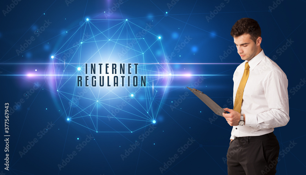 Businessman thinking about security solutions with INTERNET REGULATION inscription Businessman thinking about security solutions with INTERNET REGULATION inscription