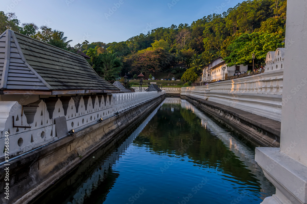 A view at sunset along the moat in front of the Temple of the Sacred Tooth Relic in Kandy, Sri Lanka, Asia A view at sunset along the moat in front of the Temple of the Sacred Tooth Relic in Kandy, Sri Lanka, Asia