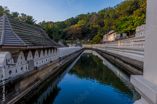 A view at sunset along the moat in front of the Temple of the Sacred Tooth Relic in  Kandy, Sri Lanka, Asia © Nicola