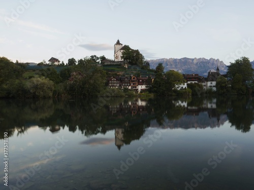 Reflection of Schloss Werdenberg Castle in Werdenbergersee in Buchs St. Gallen Switzerland photo