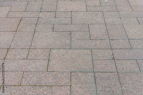 abstract background of a lined with granite tiles pavement