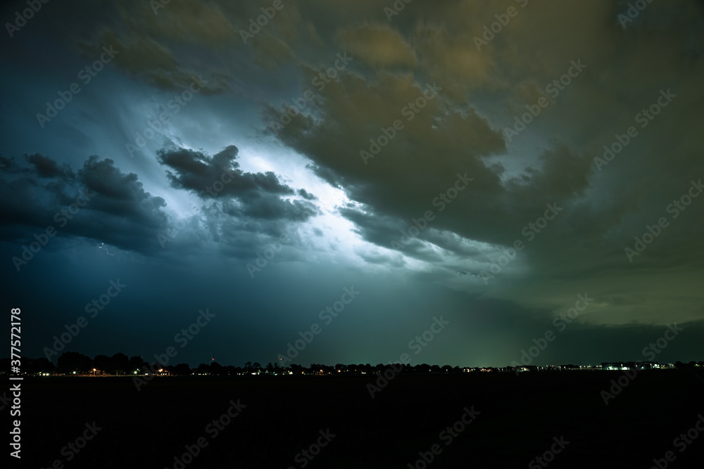 Storm clouds are illuminated by sheet lightning Storm clouds are illuminated by sheet lightning
