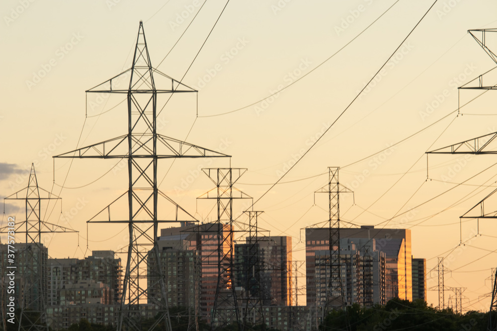 Electrical Towers and High Rise Buildings at Sunset
