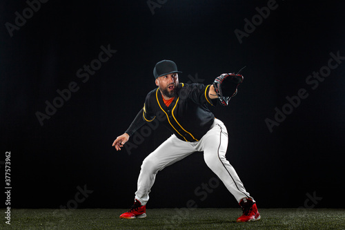 Baseball player on dark background. Ballplayer portrait.