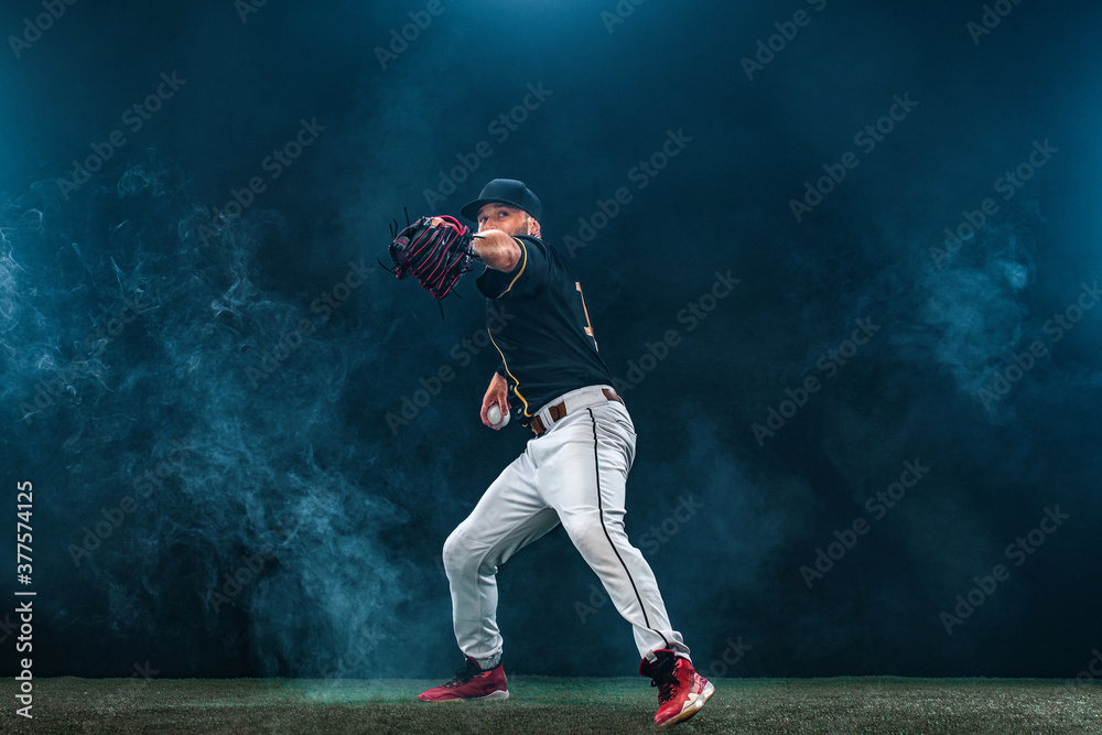 Baseball player on dark background. Ballplayer portrait.