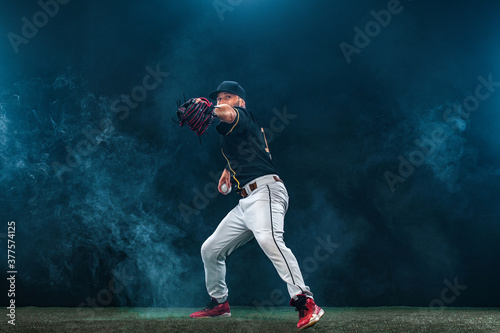 Baseball player on dark background. Ballplayer portrait.