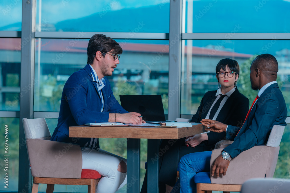 Female manager leads brainstorming meeting. Businesswoman in meeting with colleagues in conference room. Female manager leads brainstorming meeting. Businesswoman in meeting with colleagues in conference room.