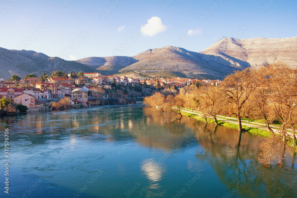 Ancient city on the banks of the river. View of Trebisnjica river and  Trebinje city  on  sunny winter day. Bosnia and Herzegovina, Republika Srpska
