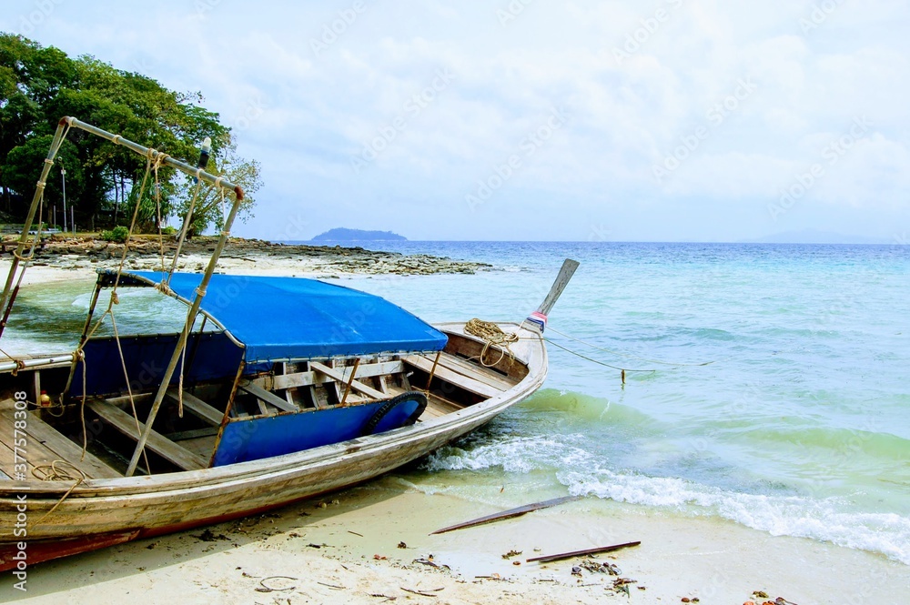 Wooden fishing boat on the shore of Phi Phi island, Krabi, Thailand Wooden fishing boat on the shore of Phi Phi island, Krabi, Thailand