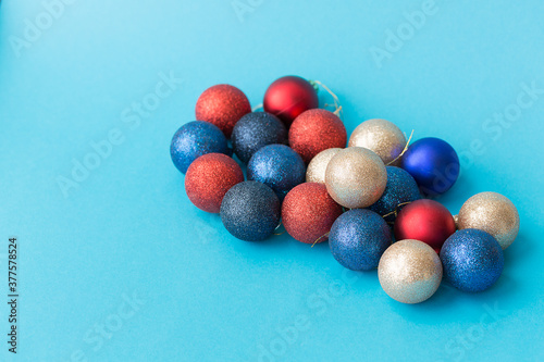 Set of multicolored Christmas balls on a blue horizontal background.