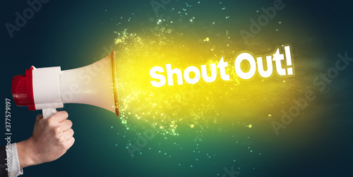 Young woman yelling to loudspeaker with Shout Out! inscription, modern media concept