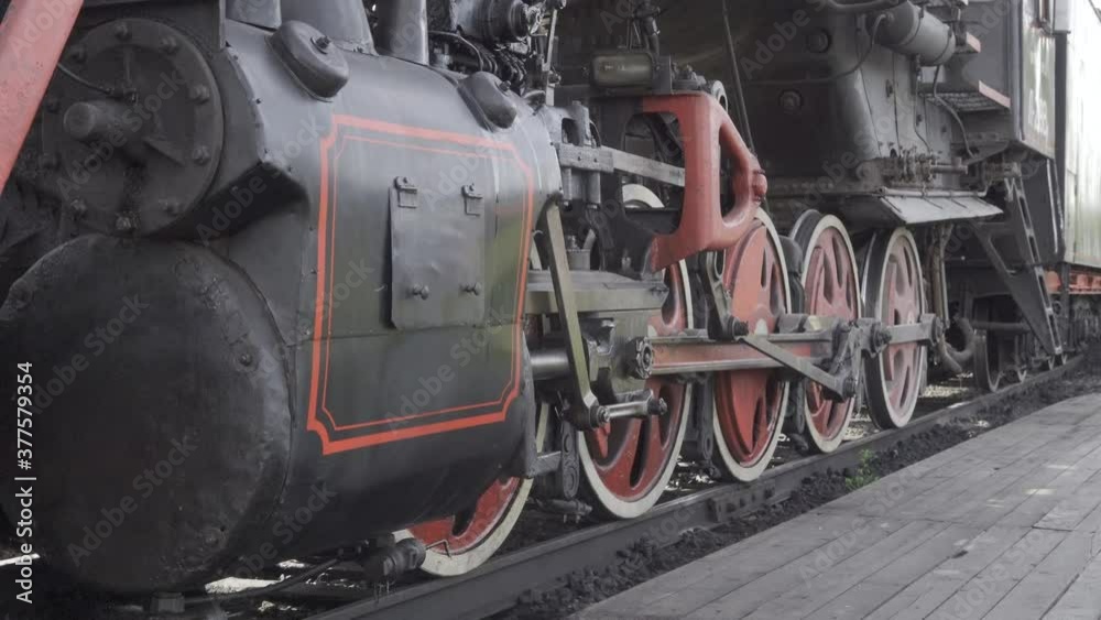 Closeup parts of old steam locomotive train wheels and rods. with original sound