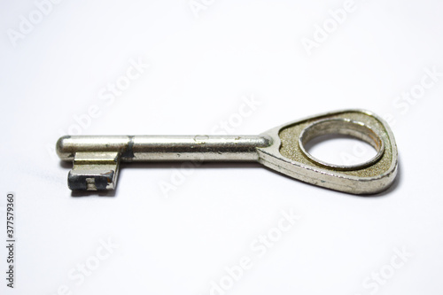 Silver key with old look and white background © Jos
