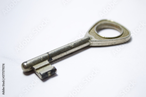Silver key with old look and white background © Jos