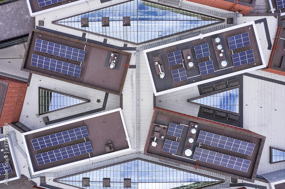 Aerial view of the solar panels on the roof of modern building.