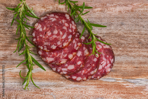 salami slices with pepper and rosemary