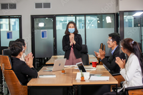 Photo of partners clapping hands after business seminar. Professional education, work meeting, Business executives clapping around conference table at office