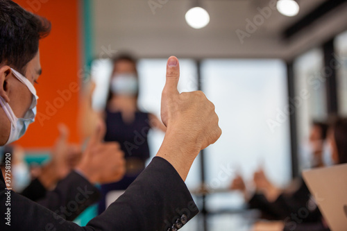 business, success, technology and office concept - business team showing thumbs up in office. Businessman showing thumbs up concept
