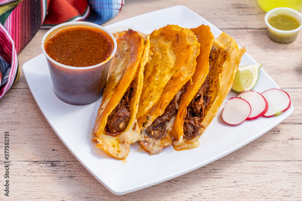 Authentic birria tacos for dipping. Mexican street food made with corn