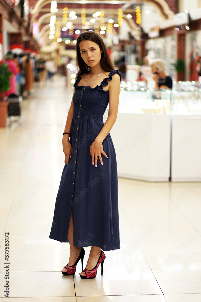brunette in a long dress in the mall brunette in a long dress in the mall