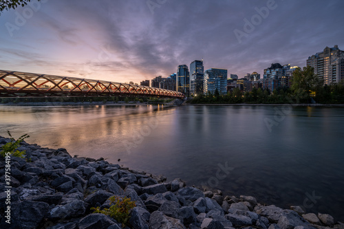 View of pedestrian bridge over the Bow River in Calgary Alberta at sunrise. 