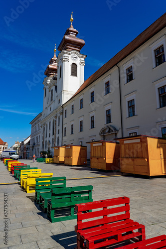 loyola saint ignatius church with colorful picnic benches at Gyor szechenyi square photo