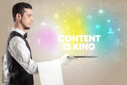 Waiter serving social networking with CONTENT IS KING inscription, new media concept